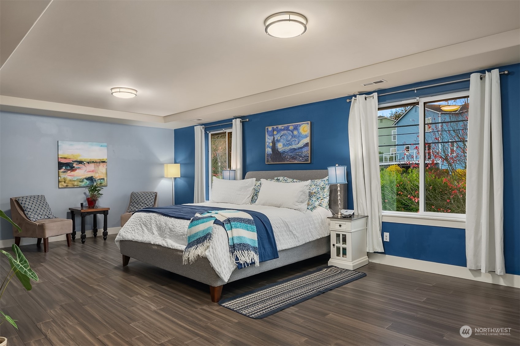 11520 56th Drive Southeast Everett, WA 98208 - Photo 18 of 30 a spacious bedroom with a bed a table and a large window