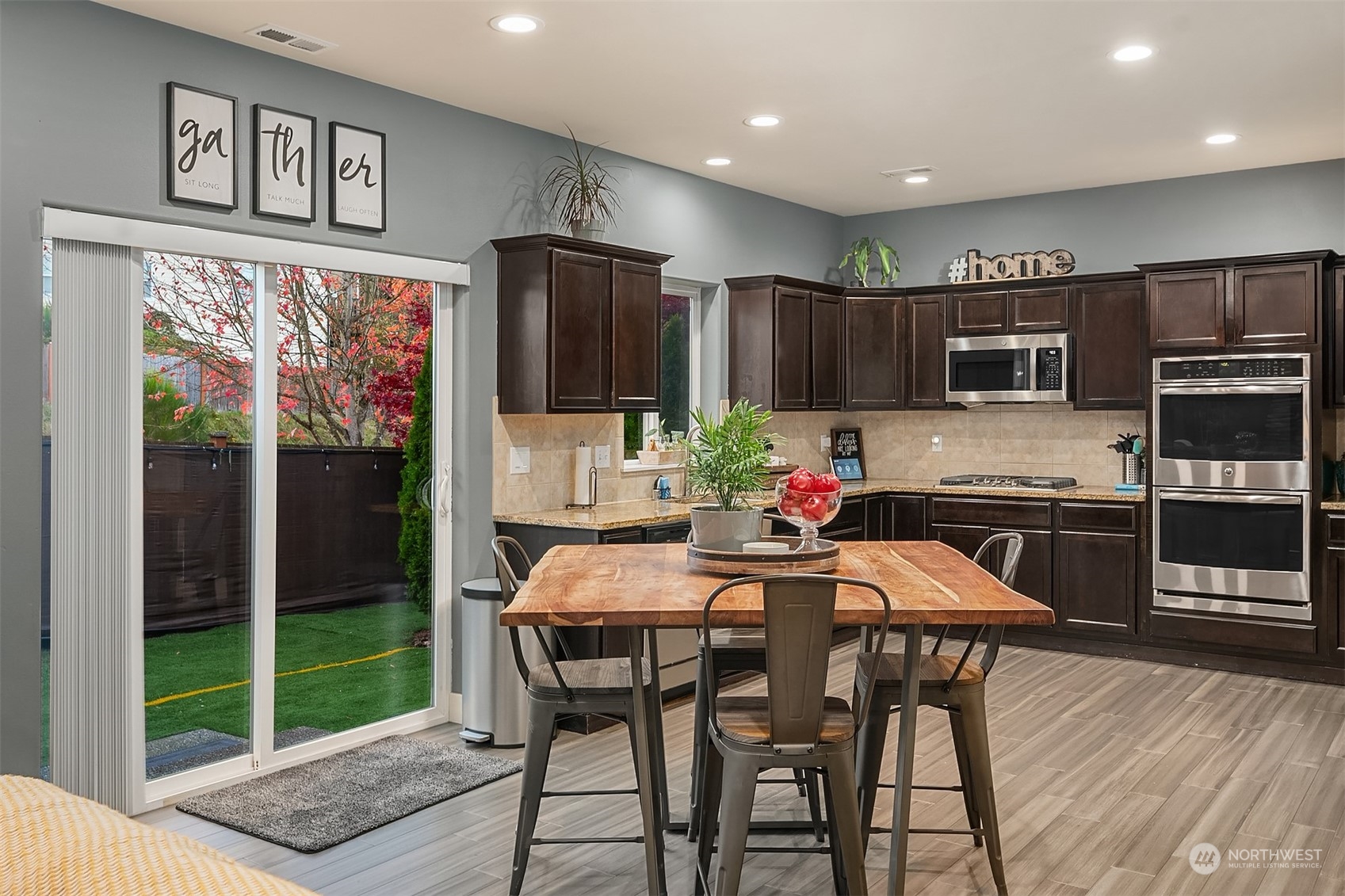 11520 56th Drive Southeast Everett, WA 98208 - Photo 8 of 30 a kitchen with stainless steel appliances granite countertop a stove a refrigerator a microwave a sink and chairs