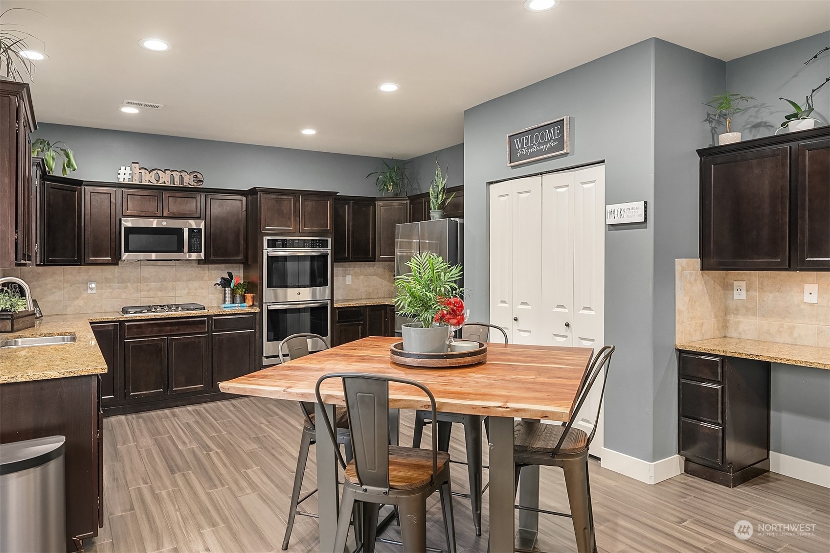 11520 56th Drive Southeast Everett, WA 98208 - Photo 9 of 30 a kitchen with stainless steel appliances wooden floor dining table and chairs