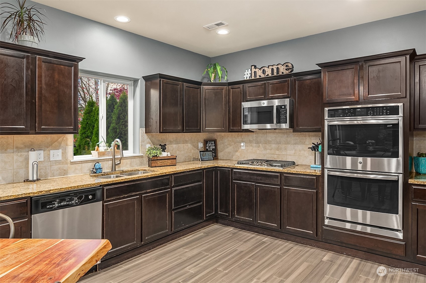 11520 56th Drive Southeast Everett, WA 98208 - Photo 10 of 30 a kitchen with stainless steel appliances granite countertop a stove microwave and sink