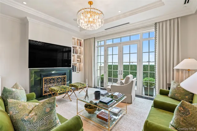 a living room with furniture a flat screen tv and a large window