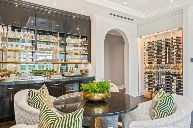 a dining room with furniture and a large window