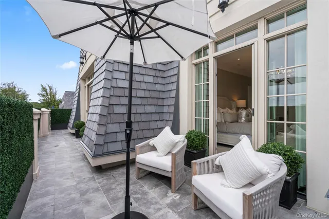 a view of house with outdoor seating and plants