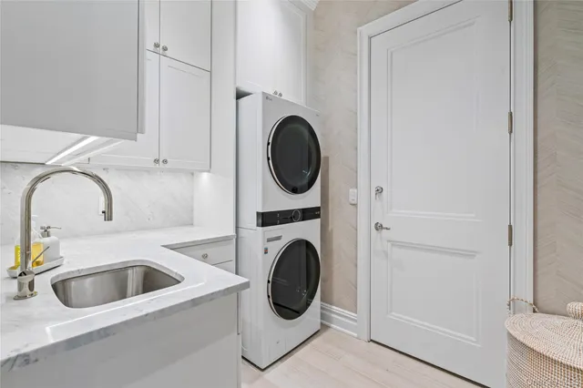 a utility room with sink dryer and washer