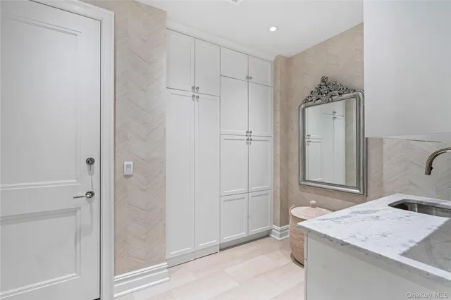 a bathroom with a granite countertop sink a mirror and shower