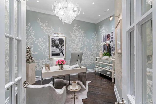 a living room with furniture and a chandelier