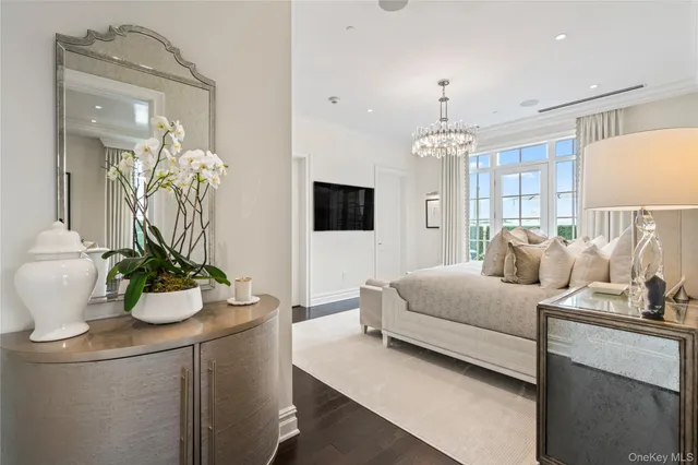 a living room with furniture and a chandelier