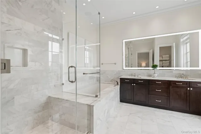 a spacious bathroom with a granite countertop sink mirror and shower