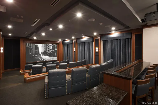 a media room with lots of chairs and a projector screen