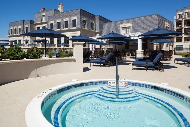 a swimming pool with outdoor seating and yard