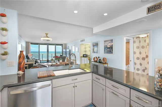 a kitchen with counter top space and living room