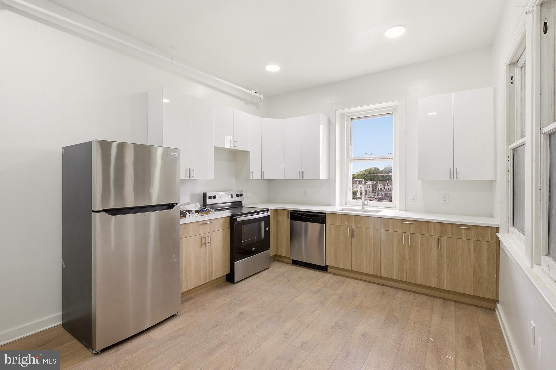 6012 Ridge Avenue, Unit 7 Philadelphia, PA 19128 - Photo 1 of 17 a kitchen with a refrigerator and a sink