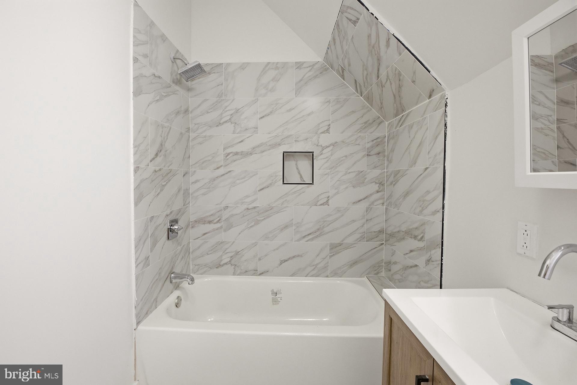 6012 Ridge Avenue, Unit 7 Philadelphia, PA 19128 - Photo 8 of 17 a bathroom with a sink and a bathtub