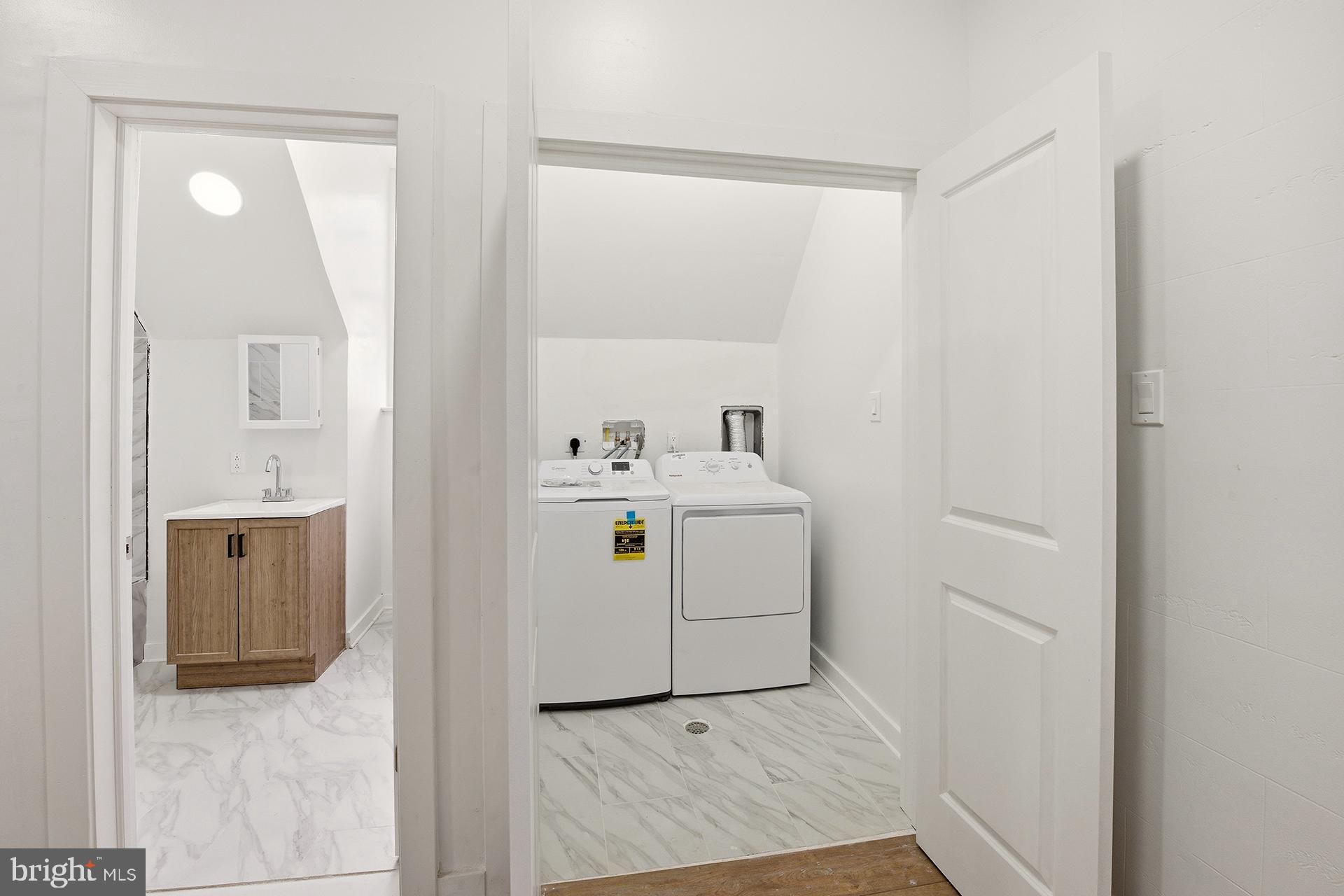 6012 Ridge Avenue, Unit 7 Philadelphia, PA 19128 - Photo 9 of 17 a utility room with cabinets washer and dryer