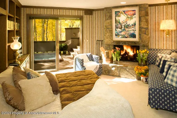 a bedroom with furniture and large windows