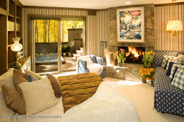 a bedroom with furniture and large windows