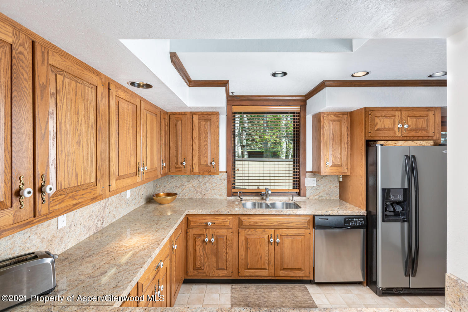 1441 Crystal Lake Road, Unit 2 Aspen, CO 81611 - Photo 5 of 20 a kitchen with stainless steel appliances granite countertop a sink a stove and a refrigerator