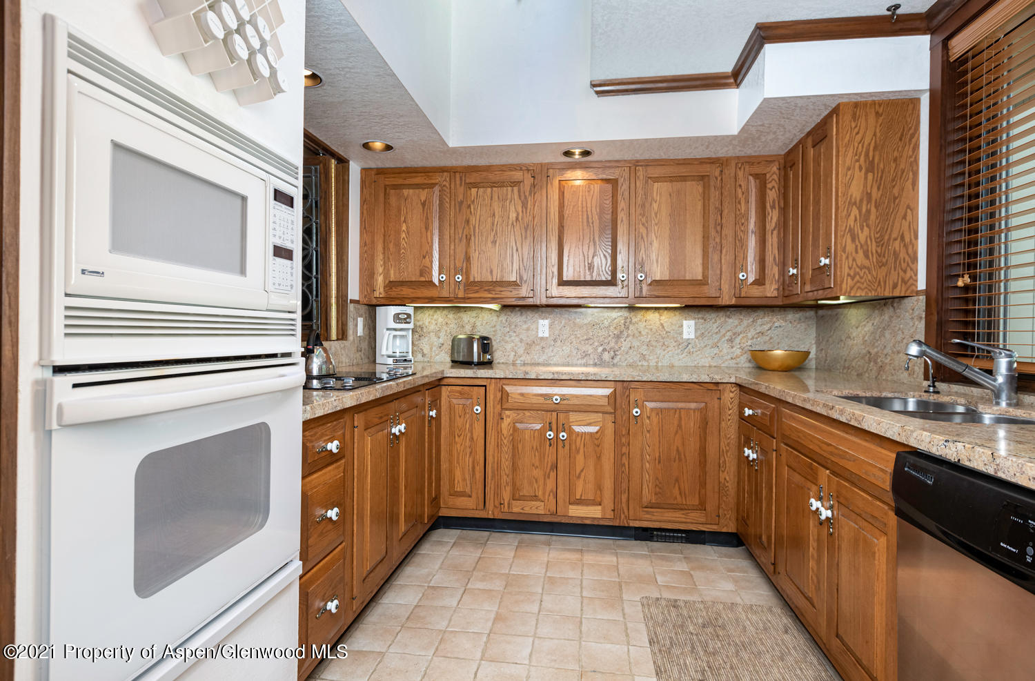 1441 Crystal Lake Road, Unit 2 Aspen, CO 81611 - Photo 6 of 20 a kitchen with stainless steel appliances granite countertop a sink a stove and cabinets