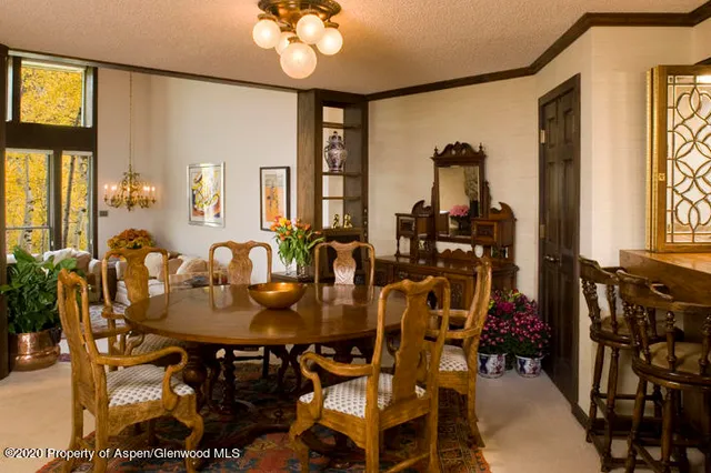 a view of a dining room with furniture and window