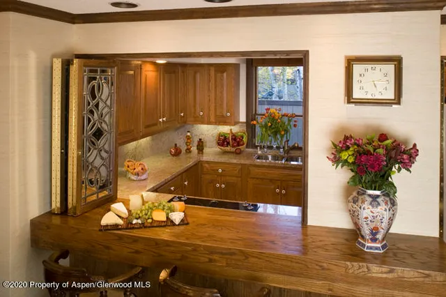 a living room with furniture flowerpot and wooden floor