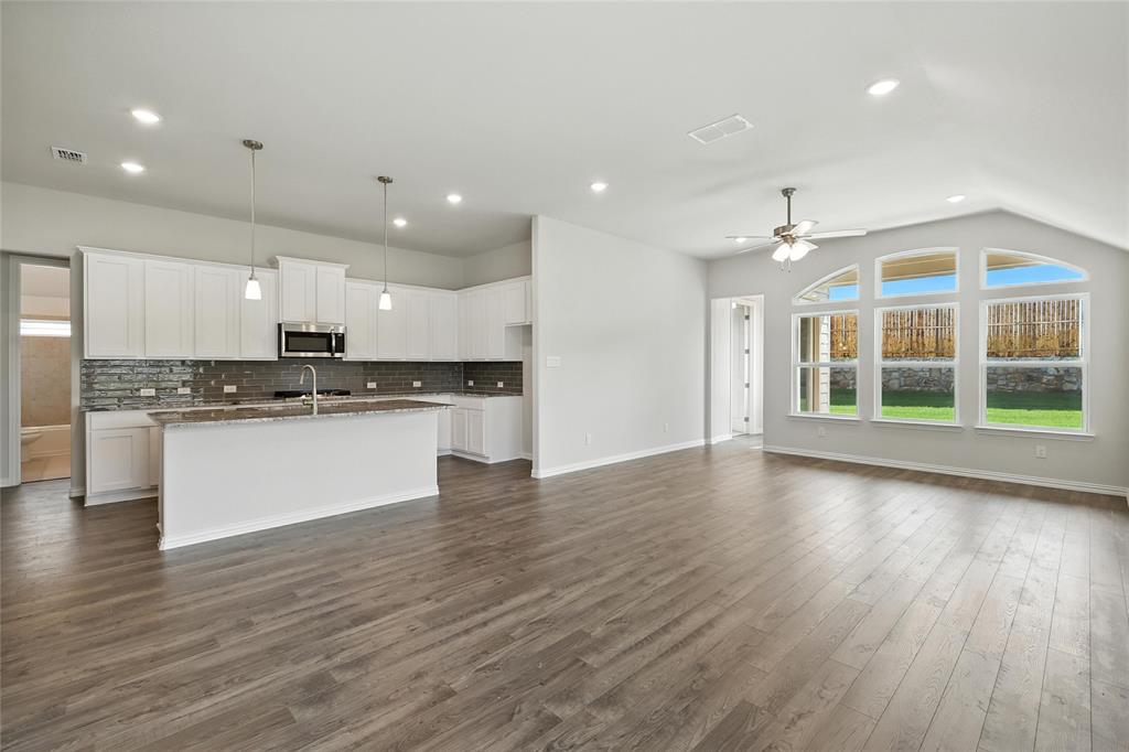2311 Ridgecrest Lane Sherman, TX 75092 - Photo 40 of 40 a view of kitchen with granite countertop stainless steel appliances refrigerator oven stove and white cabinets with wooden floor