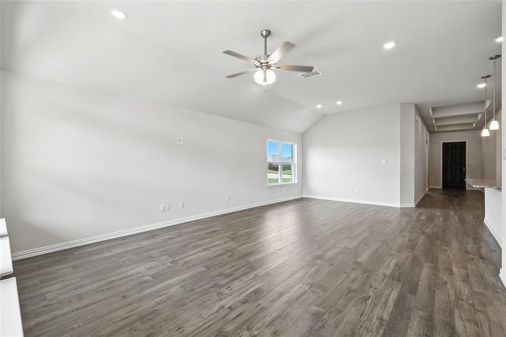 2311 Ridgecrest Lane Sherman, TX 75092 - Photo 9 of 40 an empty room with wooden floor chandelier fan and windows