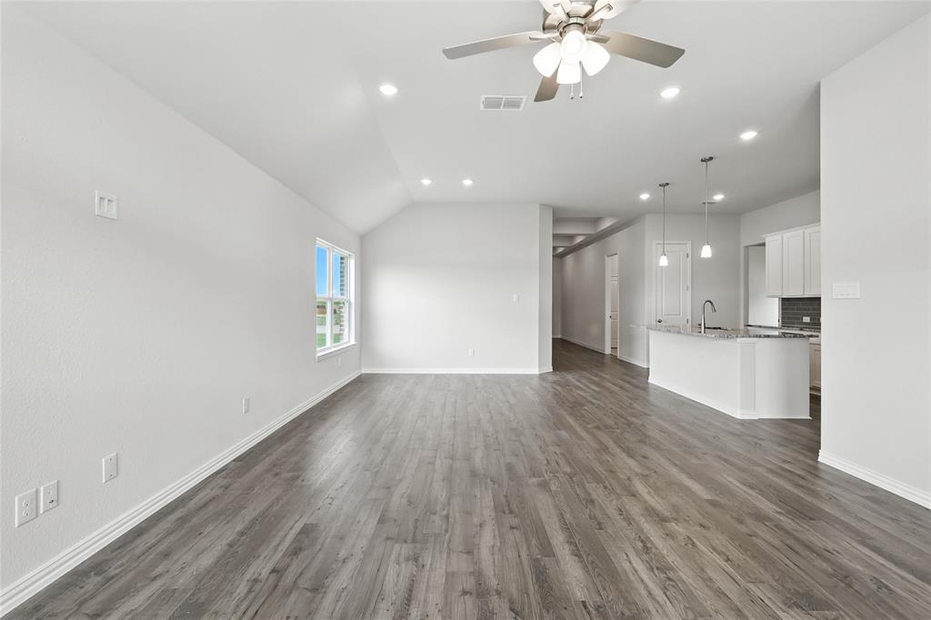 2311 Ridgecrest Lane Sherman, TX 75092 - Photo 10 of 40 a view of an empty room and kitchen with wooden floor