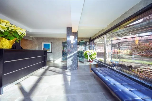 a lobby with furniture and a potted plant