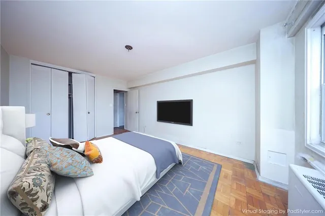 a bedroom with a bed and a flat screen tv