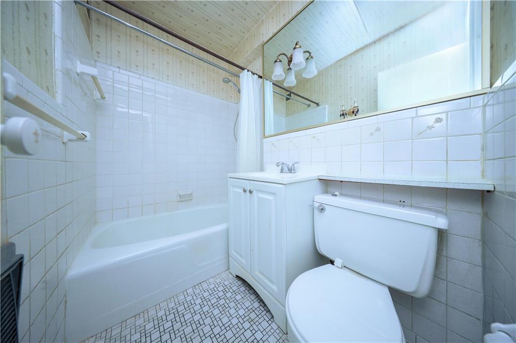 8901 Shore Road, Unit 7B Brooklyn, NY 11209 - Photo 10 of 11 a bathroom with a toilet and a bathtub