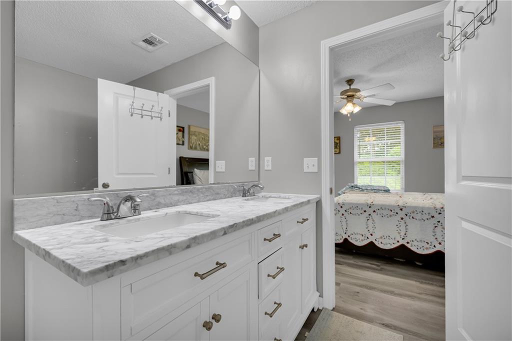 1498 Box Circle Winder, GA 30680 - Photo 38 of 56 a bathroom with a granite countertop sink and a mirror