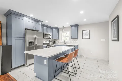 a kitchen with stainless steel appliances refrigerator stove microwave and cabinets