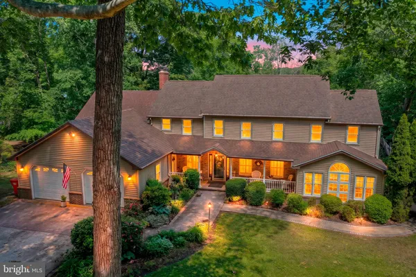 an aerial view of a house with swimming pool and garden view