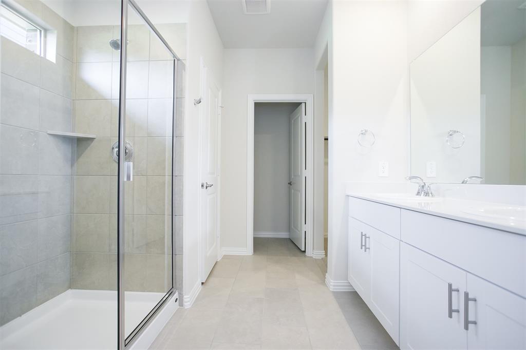404 Castle Road Sherman, TX 75092 - Photo 10 of 25 a bathroom with a double vanity sink and mirror