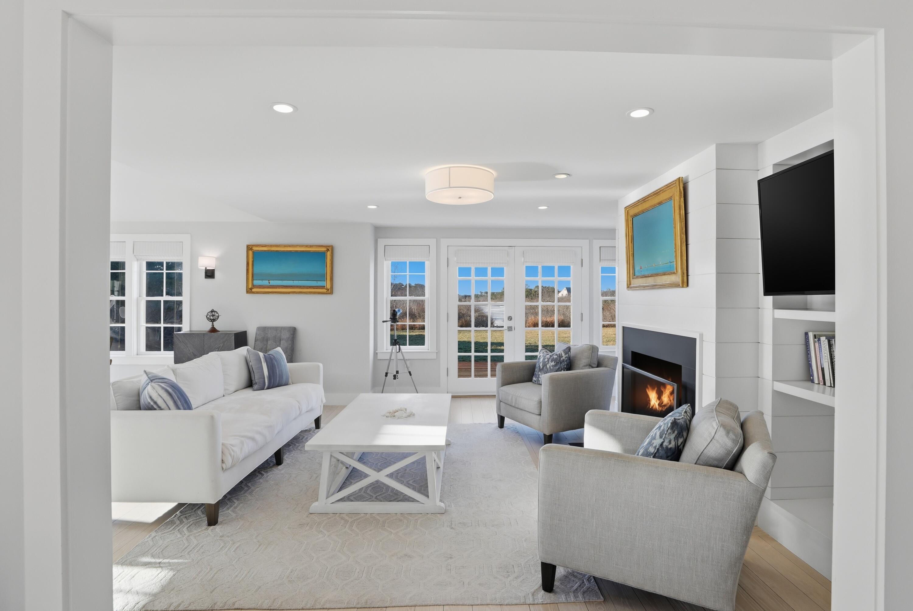 4 Goose Cove Way Nantucket, MA 02554 - Photo 9 of 36 a living room with furniture a fireplace and a flat screen tv