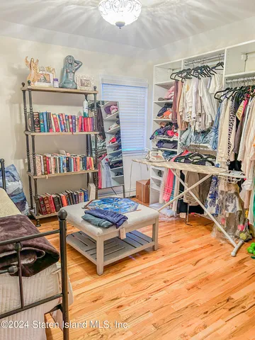 a view of walk in closet with clothes