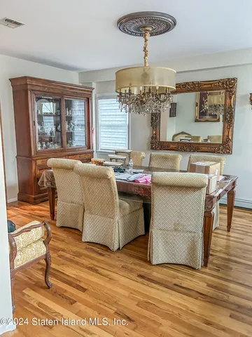 a living room with a couch and chandelier