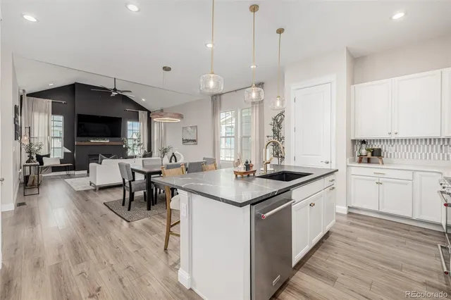 a large kitchen with kitchen island a sink table and chairs