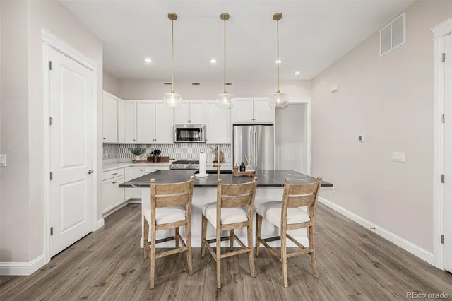 a view of a dining room with furniture wooden floor and a chandelier