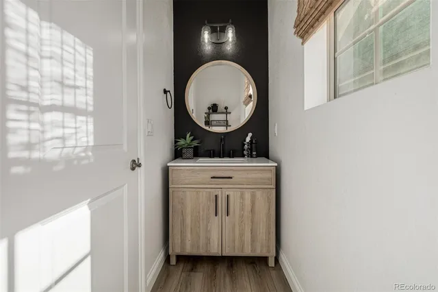 a bathroom with a toilet and a mirror