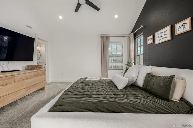 a bedroom with a bed and a flat screen television