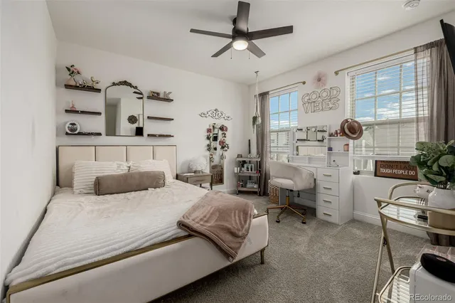 a bedroom with a large bed and a chair