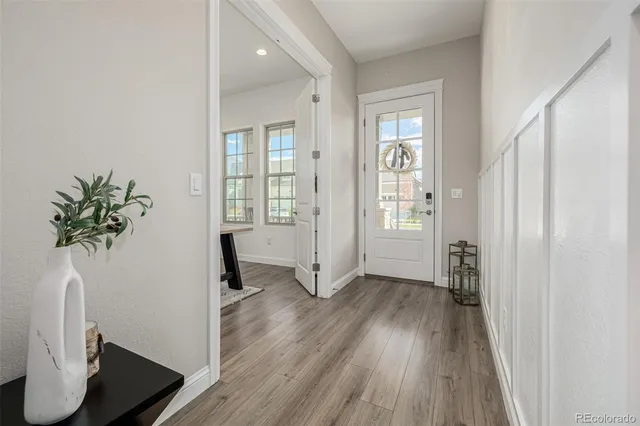 a view of an entryway with wooden floor and a window