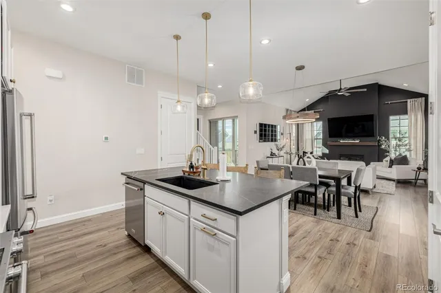 a kitchen with stainless steel appliances granite countertop a stove a sink and a microwave