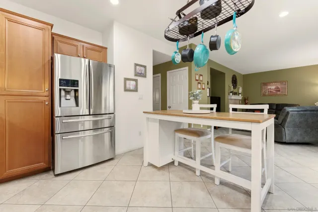 a kitchen with stainless steel appliances a stove a sink and a refrigerator