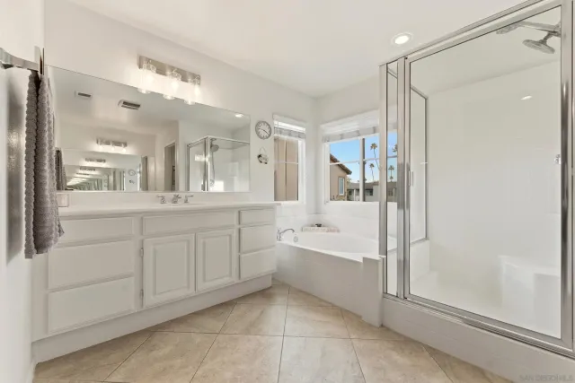 a spacious bathroom with a shower sink vanity and mirror