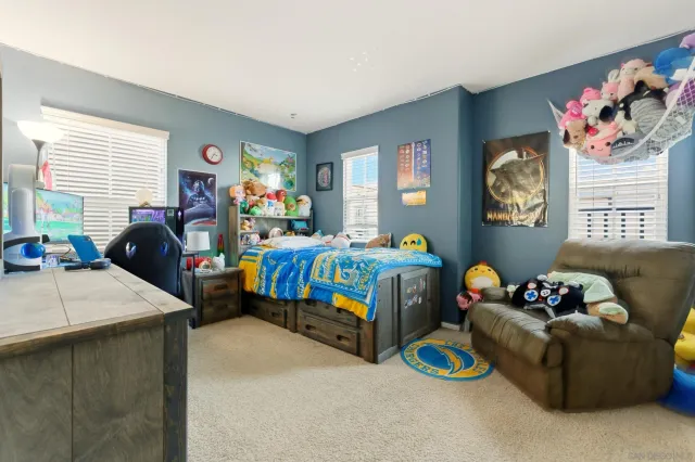 a bedroom that has a bed and a dresser in it