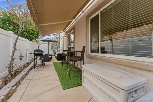 a view of house with backyard and outdoor seating