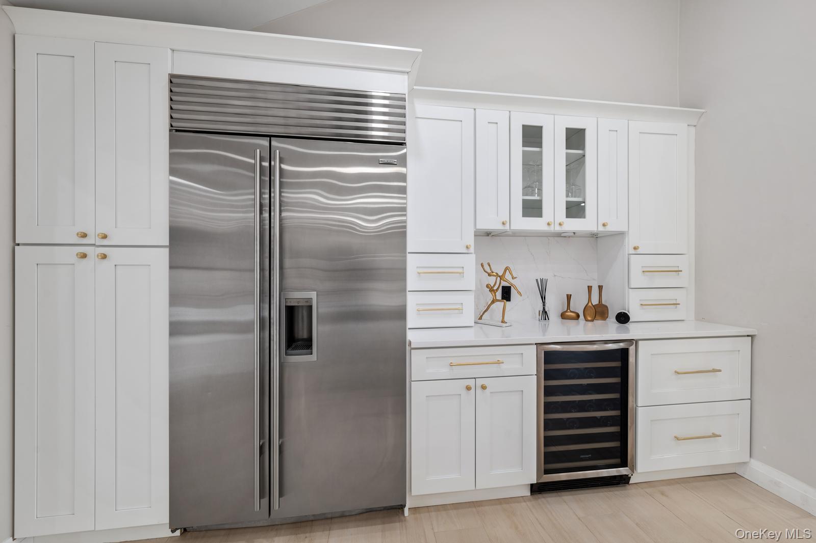 111 Mill River Road Oyster Bay, NY 11771 - Photo 12 of 48 a kitchen with cabinets and stainless steel appliances
