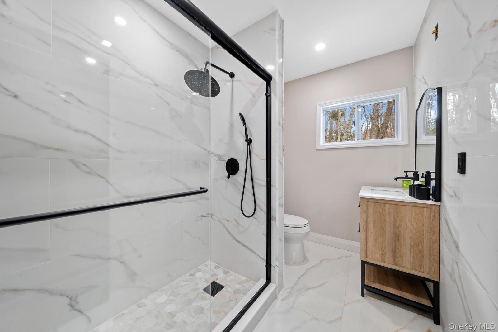 111 Mill River Road Oyster Bay, NY 11771 - Photo 17 of 48 a bathroom with a granite countertop sink a toilet and shower